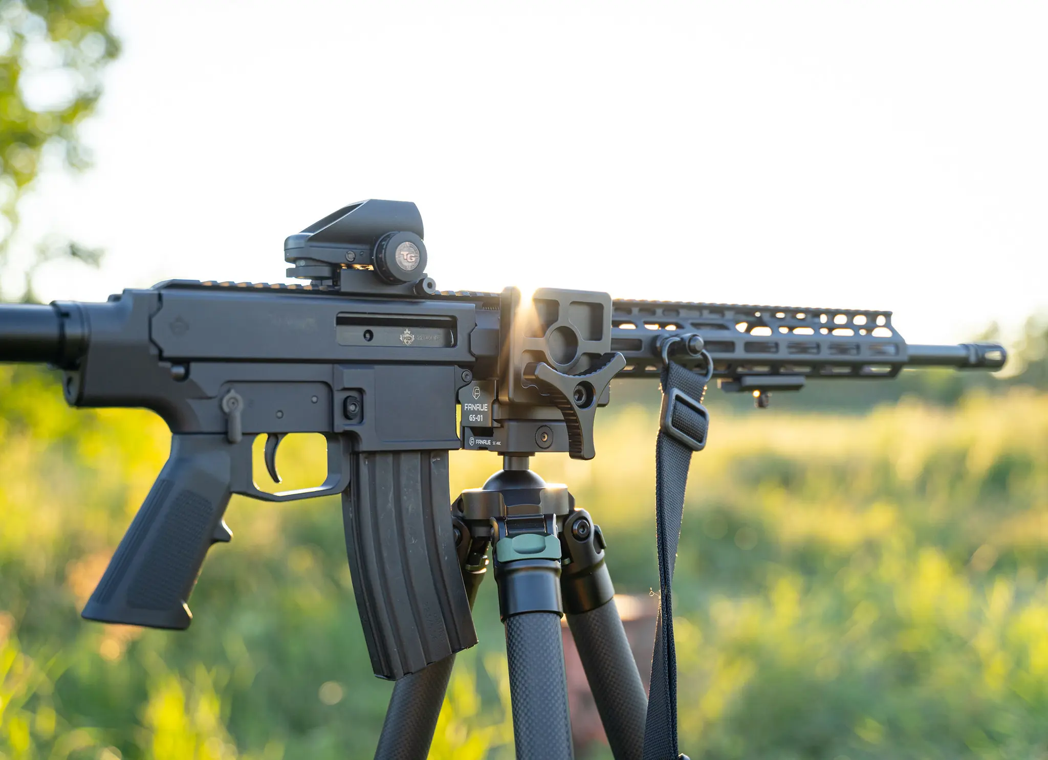 Carbon fiber hunting tripod set up on uneven outdoor terrain